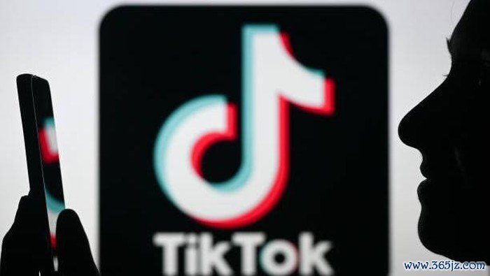 EDMONTON, CANADA - APRIL 28:An image of a woman holding a cell phone in front of the Tik Tok logo displayed on a computer screen, on April 29, 2024, in Edmonton, Canada. (Photo by Artur Widak/NurPhoto via Getty Images)